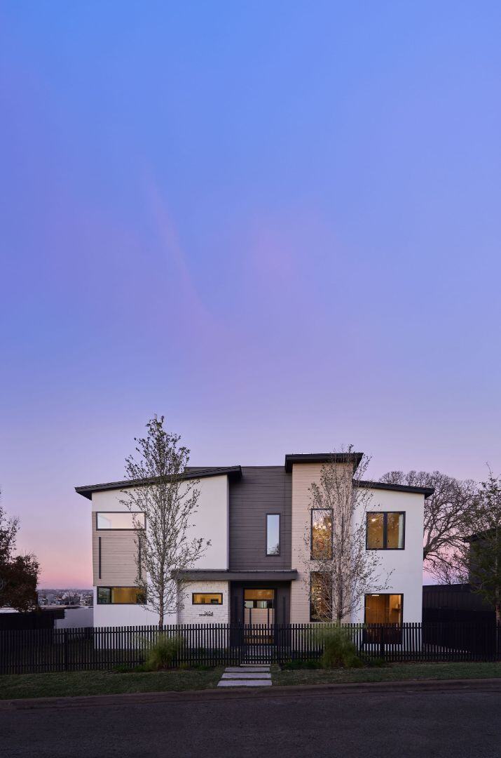 Modern two-story home with sleek architecture at sunset. Austin, TX | CKN Homes