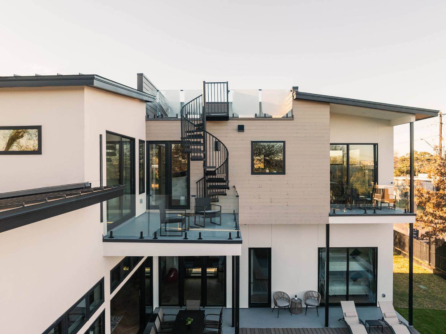 Rooftop terrace with spiral staircase and scenic city views. Austin, TX | CKN Homes