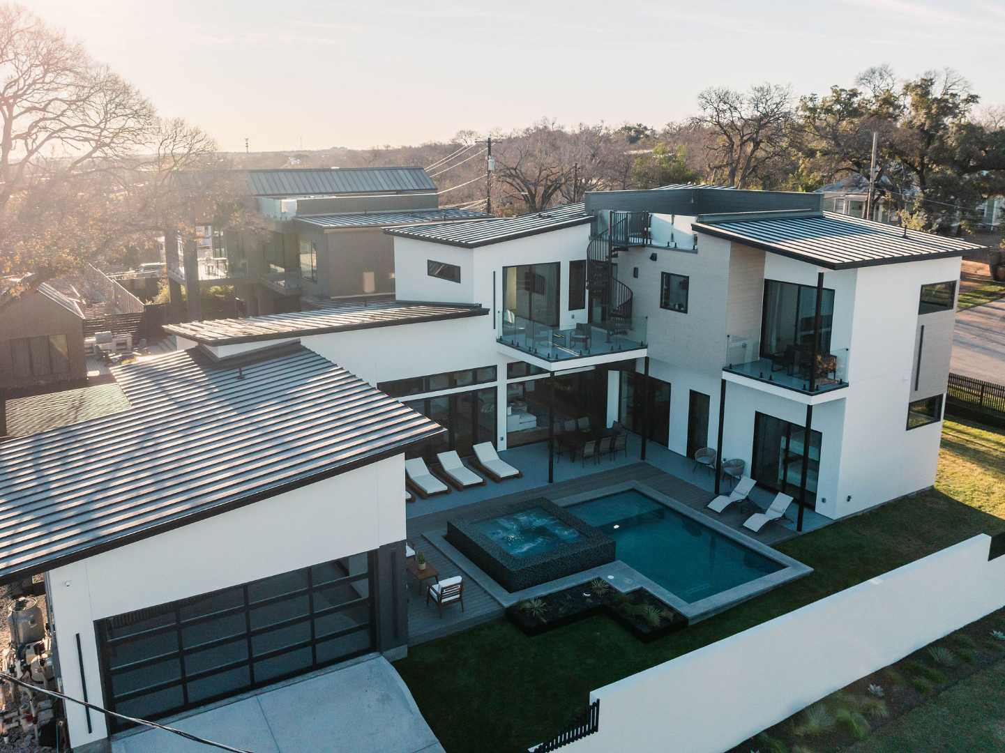 Elegant home with spacious outdoor pool and seating areas. Austin, TX | CKN Homes