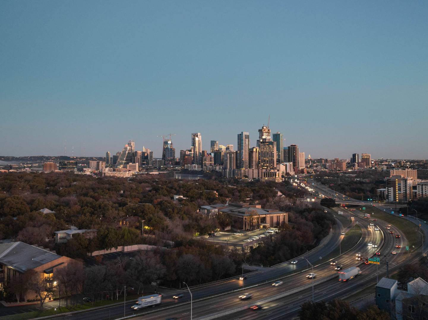 Austin skyline at night with city lights and highways. Austin, TX | CKN Homes