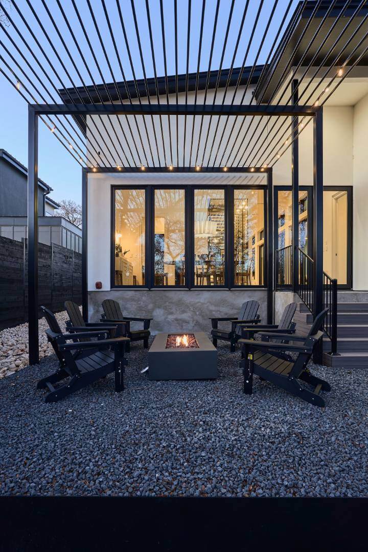 Stylish pergola-covered fire pit lounge. Austin, TX | CKN Homes