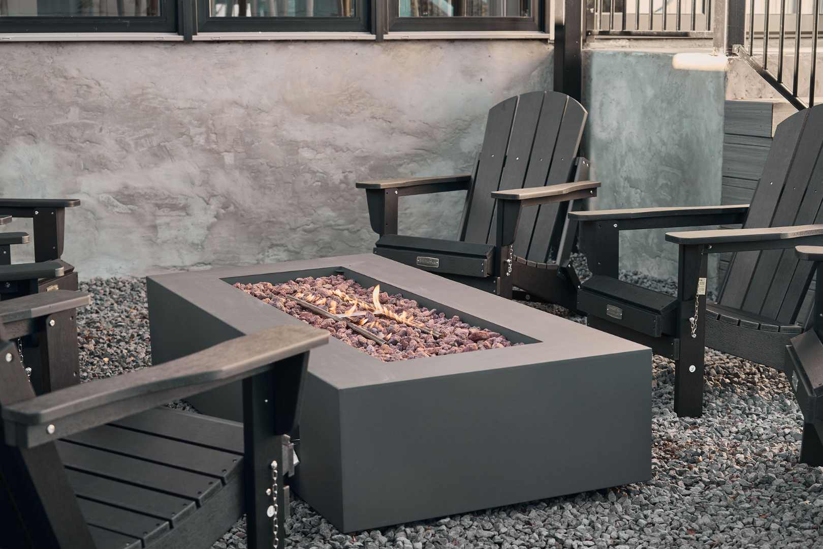 Chic fire pit with Adirondack chairs. Austin, TX | CKN Homes