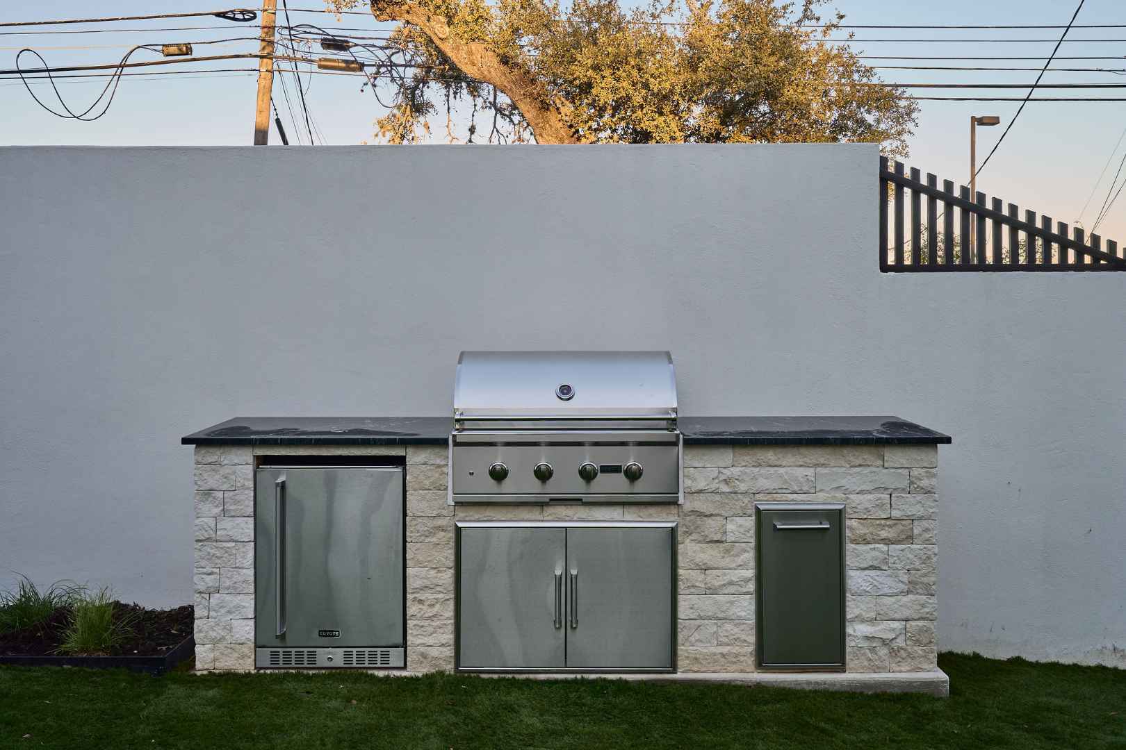 Outdoor stainless steel kitchen with built-in grill station. Austin, TX | CKN Homes