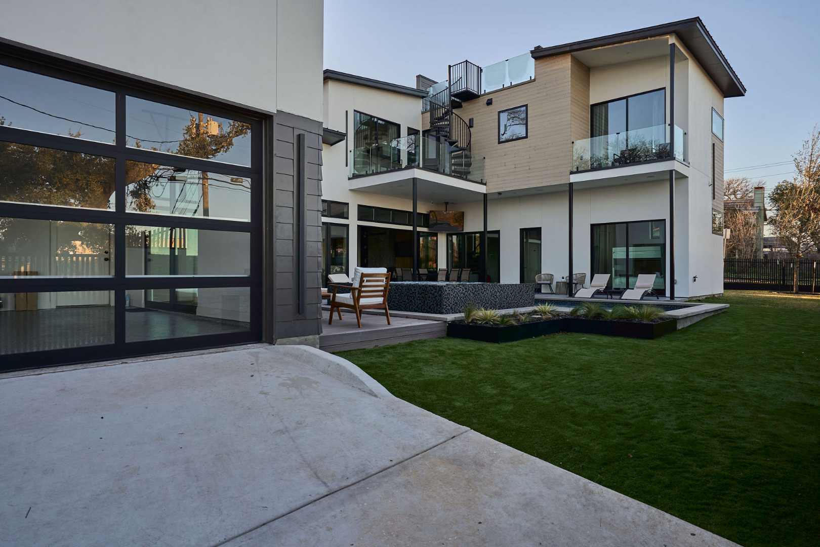 Modern luxury home with a glass garage and lush lawn. Austin, TX | CKN Homes