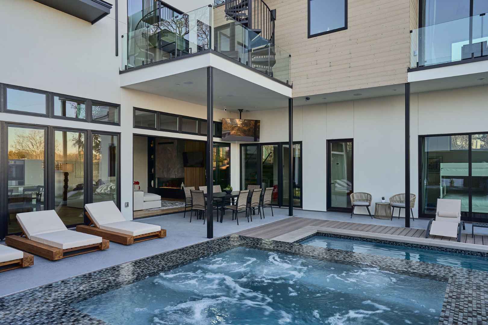 Pool with bubbling spa and modern outdoor living space. Austin, TX | CKN Homes