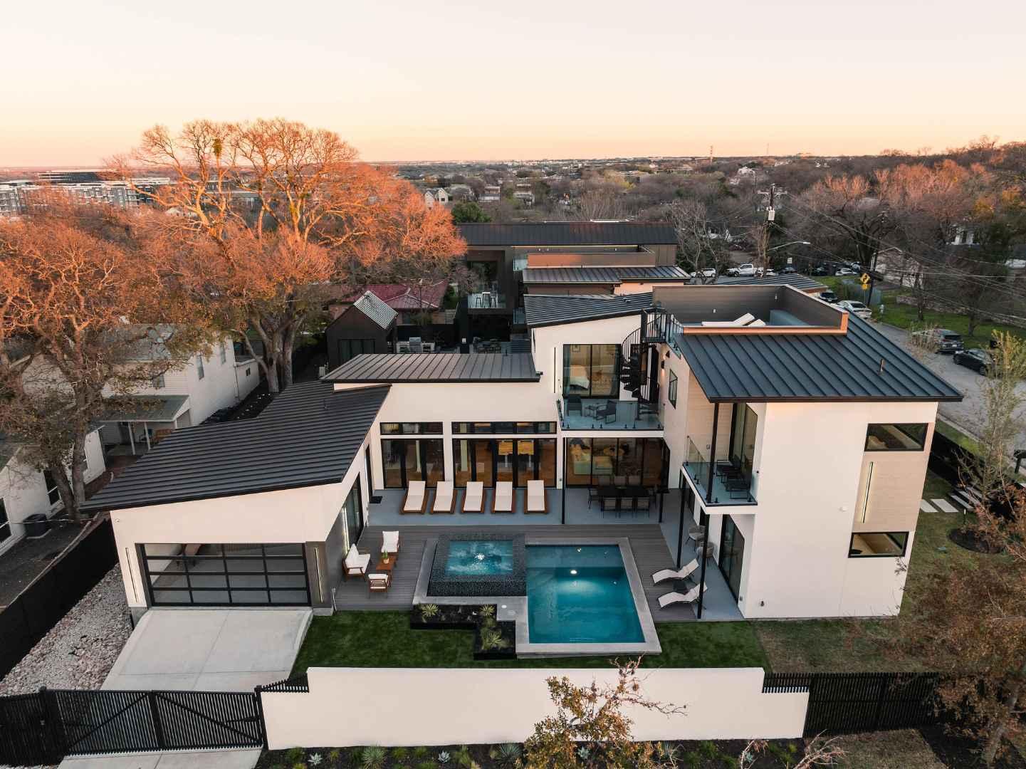 Sophisticated two-story home featuring glass balconies and patio. Austin, TX | CKN Homes