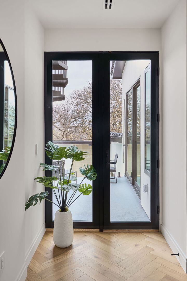 Balcony access through sleek black-framed glass doors. Austin, TX | CKN Homes