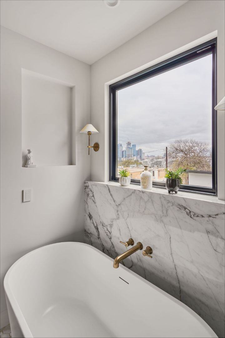 Luxurious bathtub with city skyline view. Austin, TX | CKN Homes